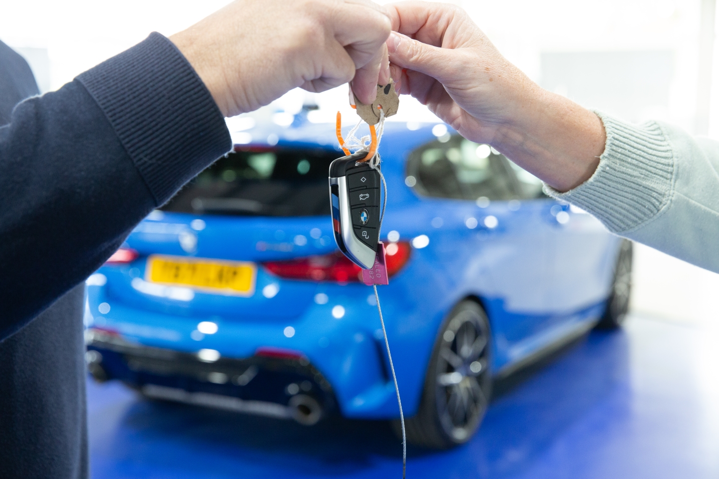 car keys being handed over in showroom