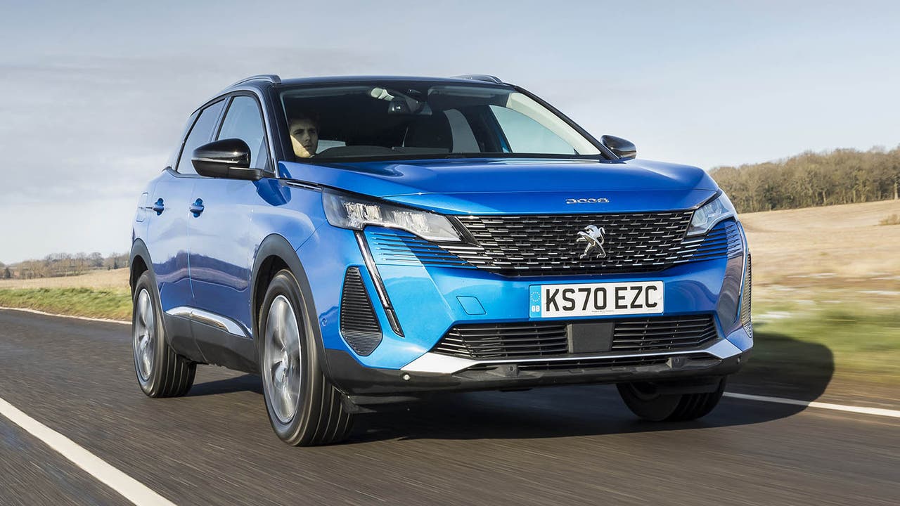 Blue Peugeot 3008 facelift driving down a road in early spring light