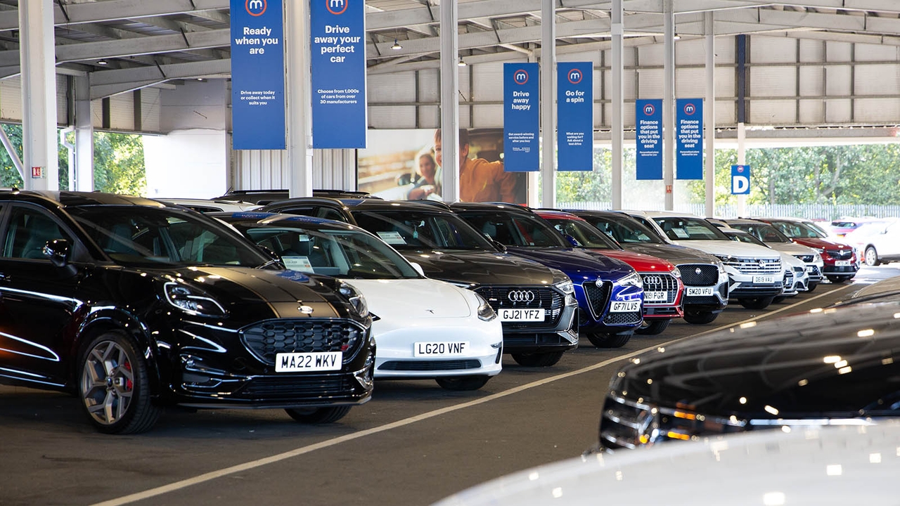 Row of cars for sale at a Motorpoint store