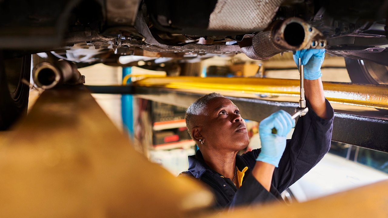 Car mechanic inspecting car