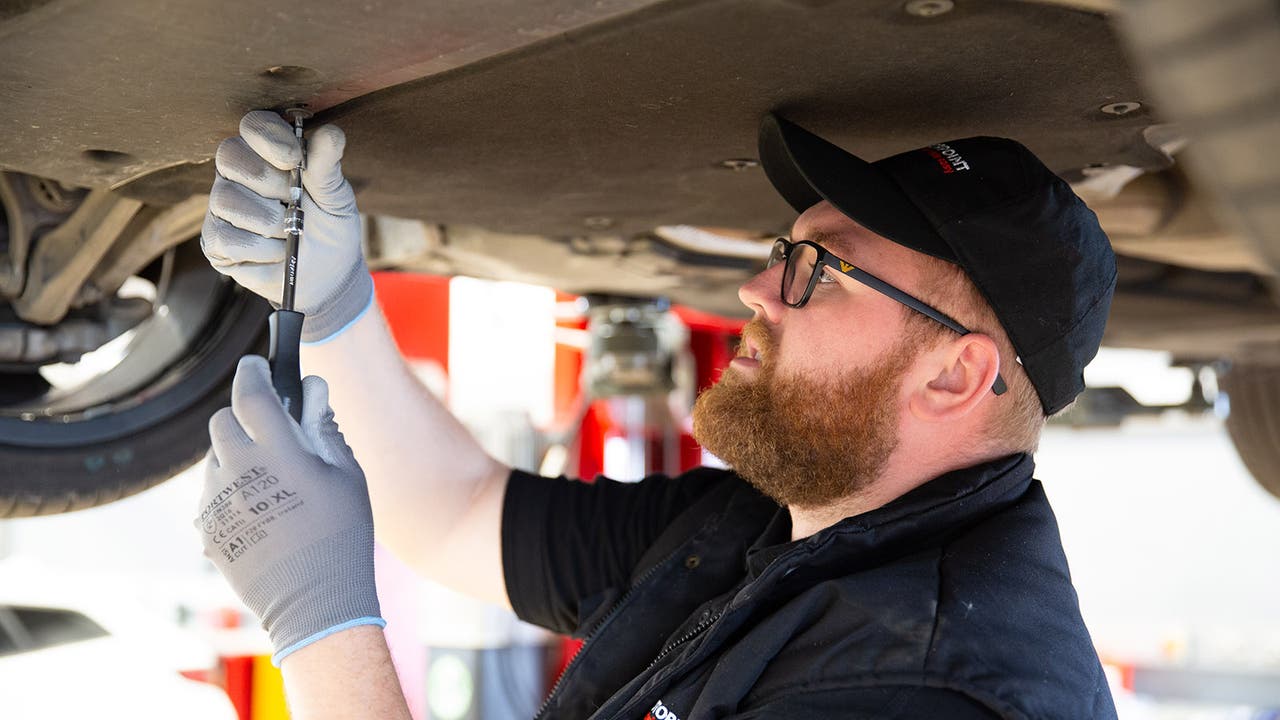 Motorpoint service technician checks the underbody of a car
