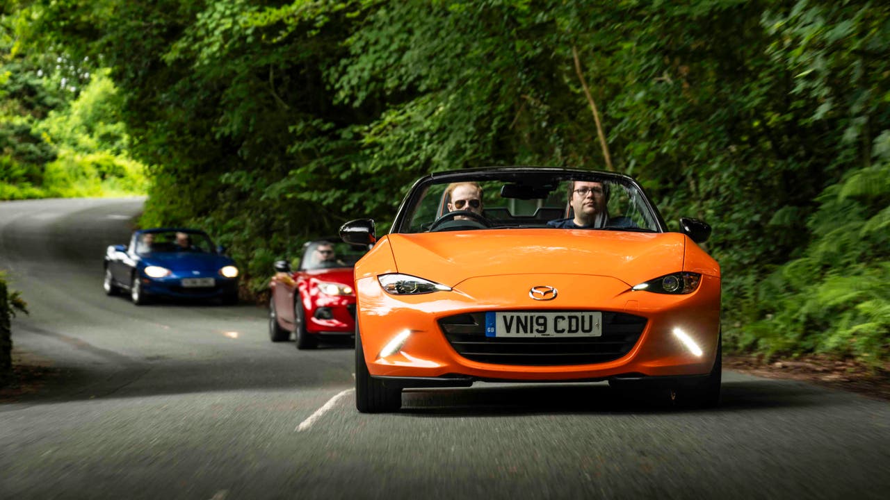 Mazda MX-5s driving on country road