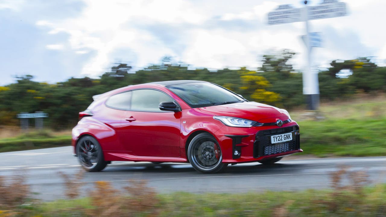Red Toyota GR Yaris driving enthusiastically