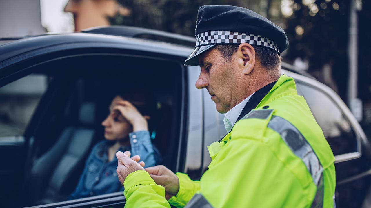 Police issuing a ticket to a speeding driver