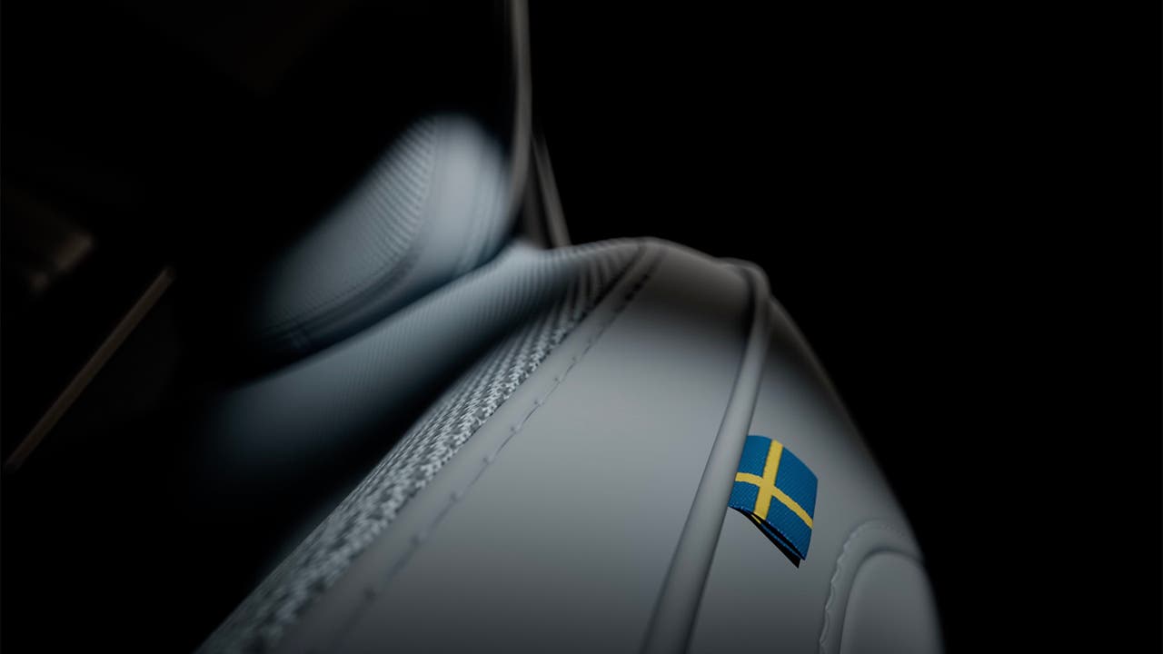Volvo EX30 teaser image, leather seat close up with Swedish flag label
