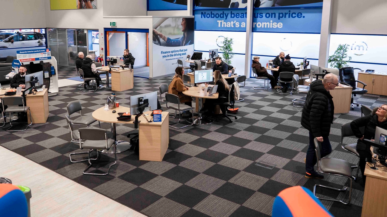 Busy Motorpoint showroom with lots of customers sat at salespersons' desks