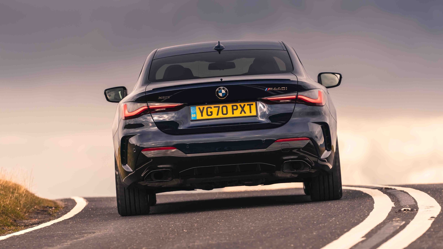 BMW 4 Series driving rear end view