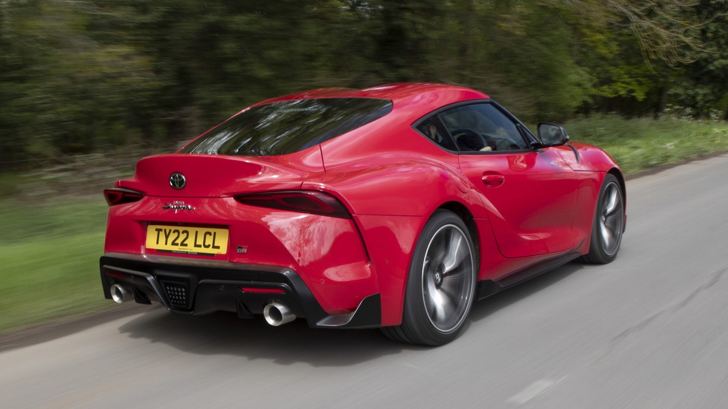 Toyota GR Supra driving rear/side view