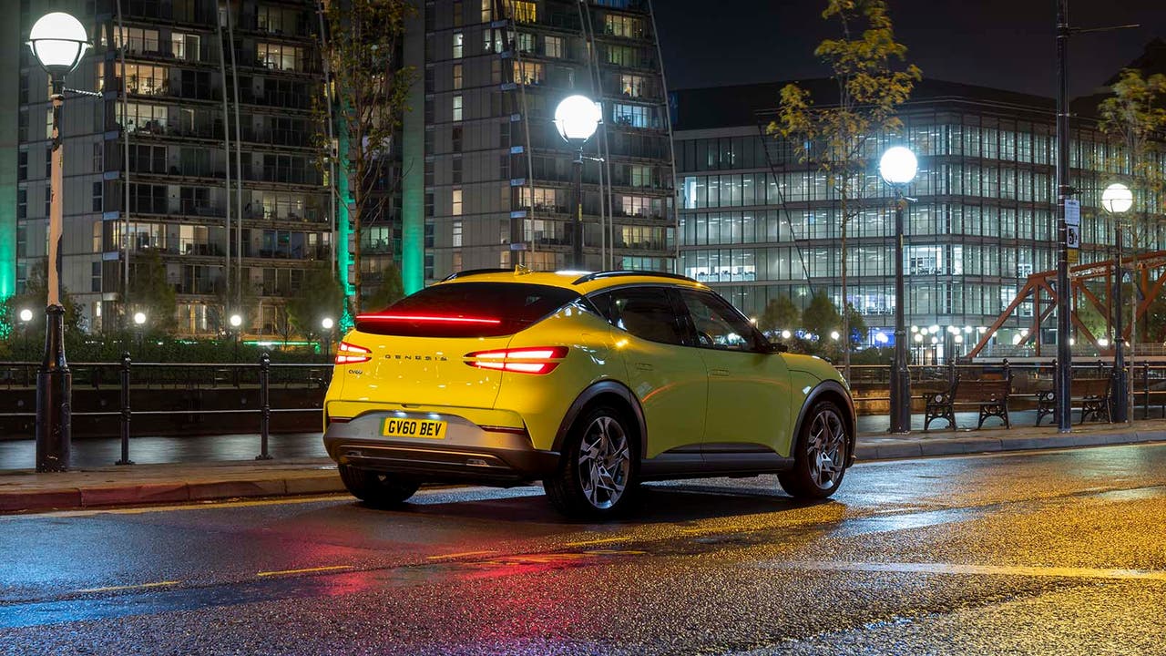 A Genesis GV60 in yellow, static shot