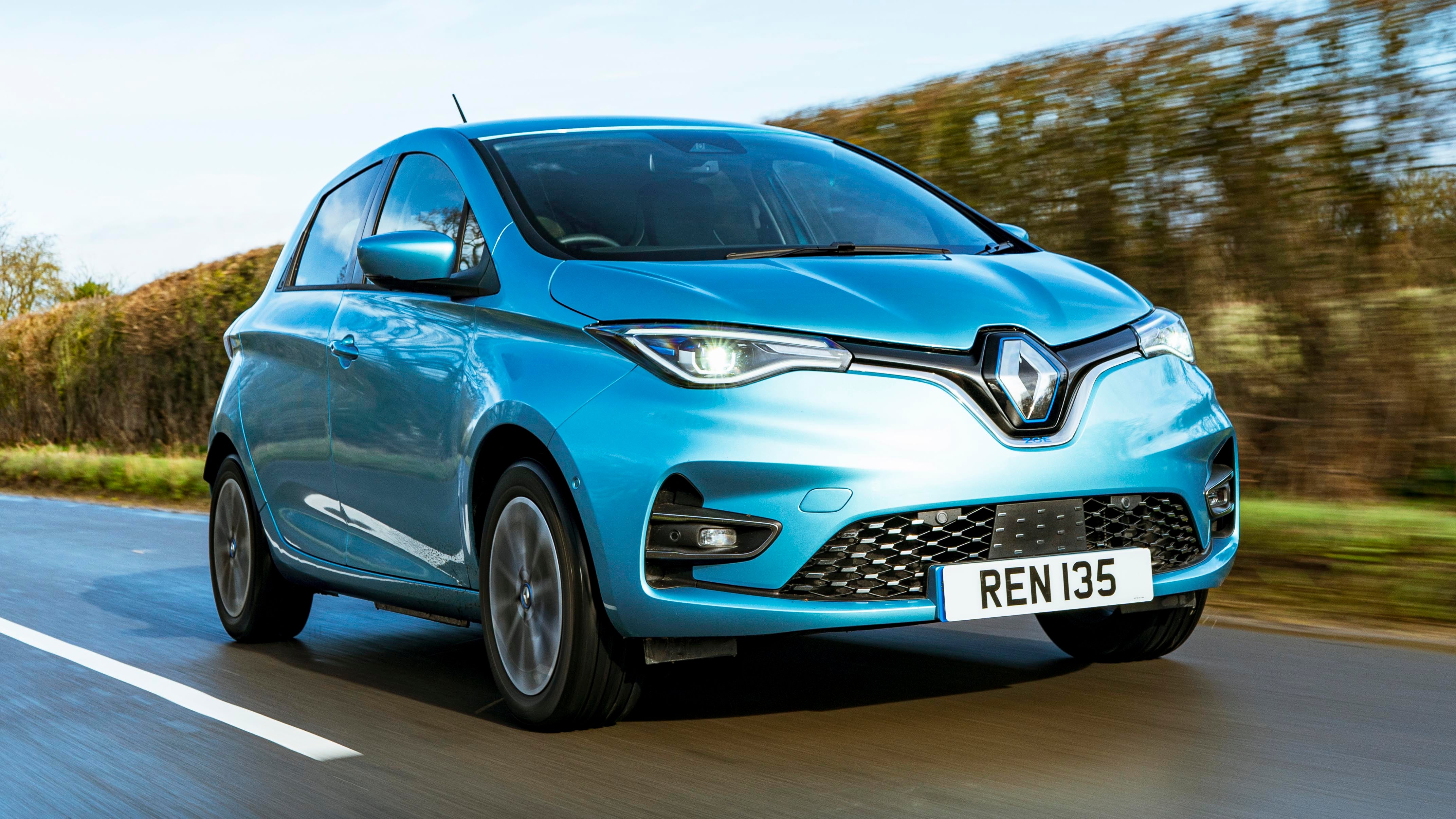 Blue Renault Zoe driving on road next to hedgerow