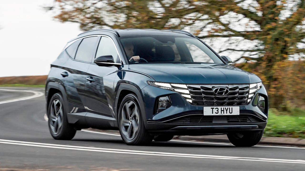 Dark Blue Hyundai Tucson cornering on a UK road