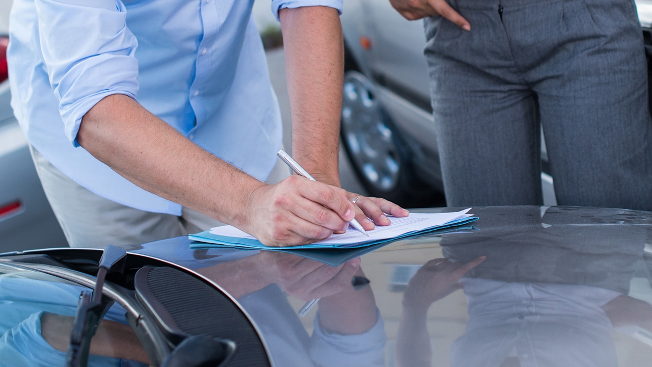 Car buyer writing down details