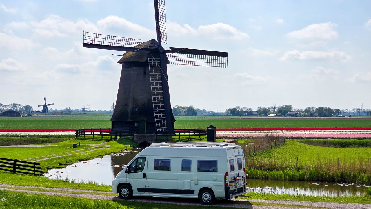 Campervan in front of Dutch windmill
