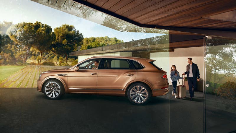 Family with bronze-coloured Bentley Bentayga EWB