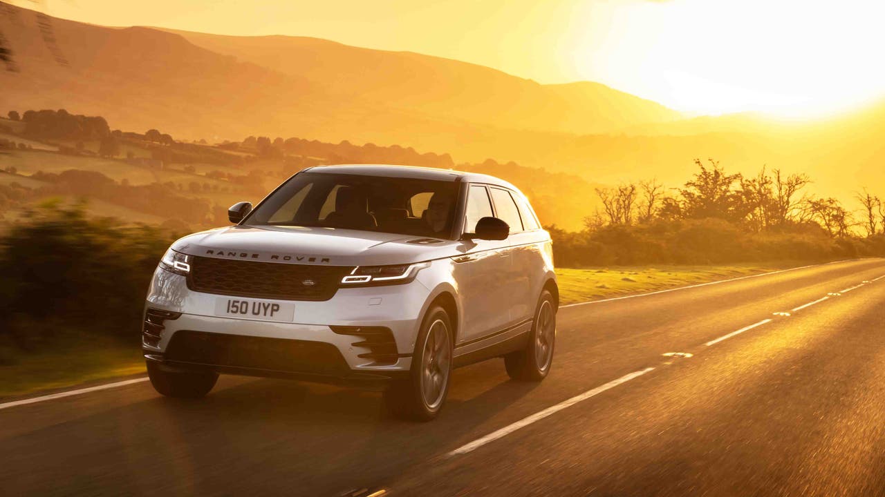 Range Rover Velar driving in front of sunset