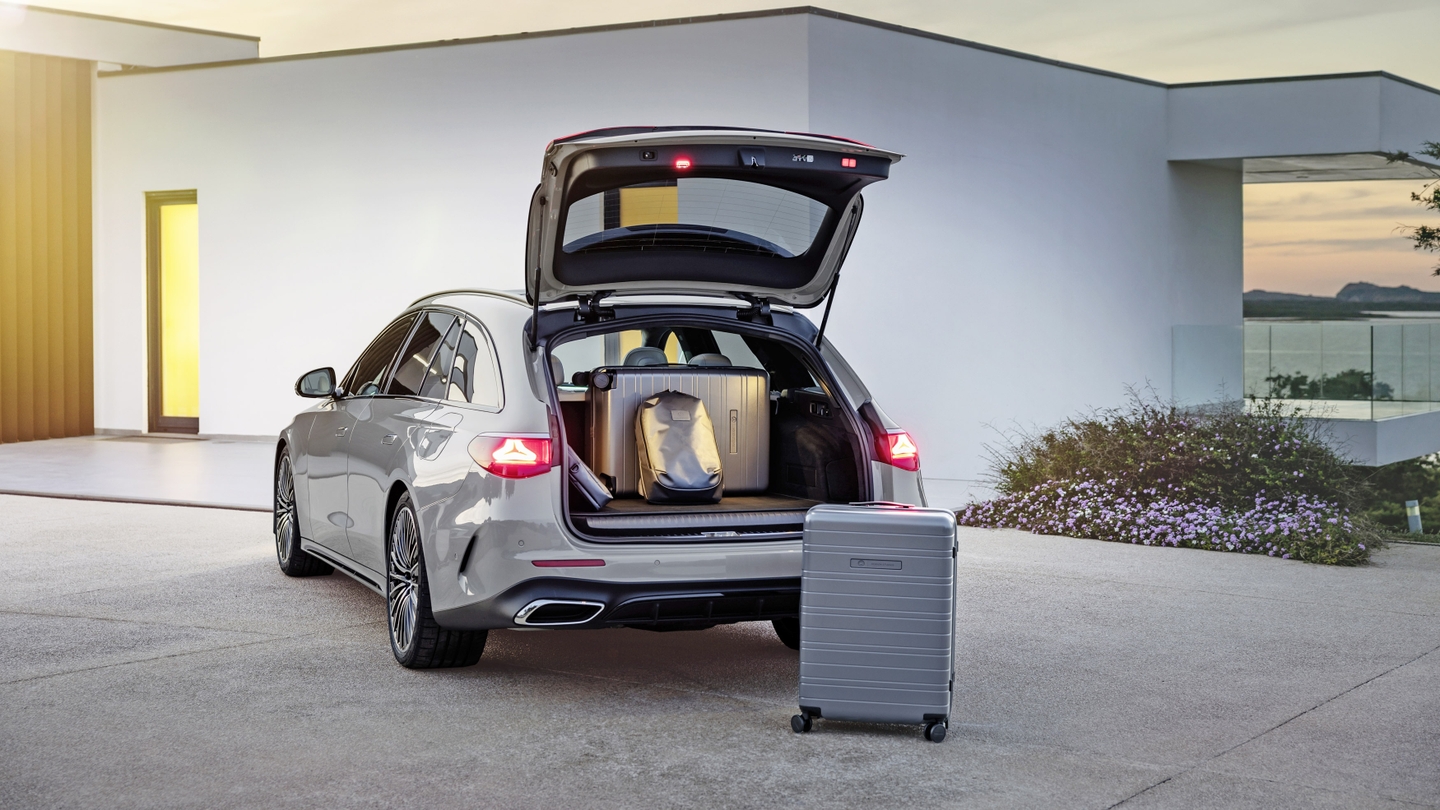 estate car with boot open in front of modern house