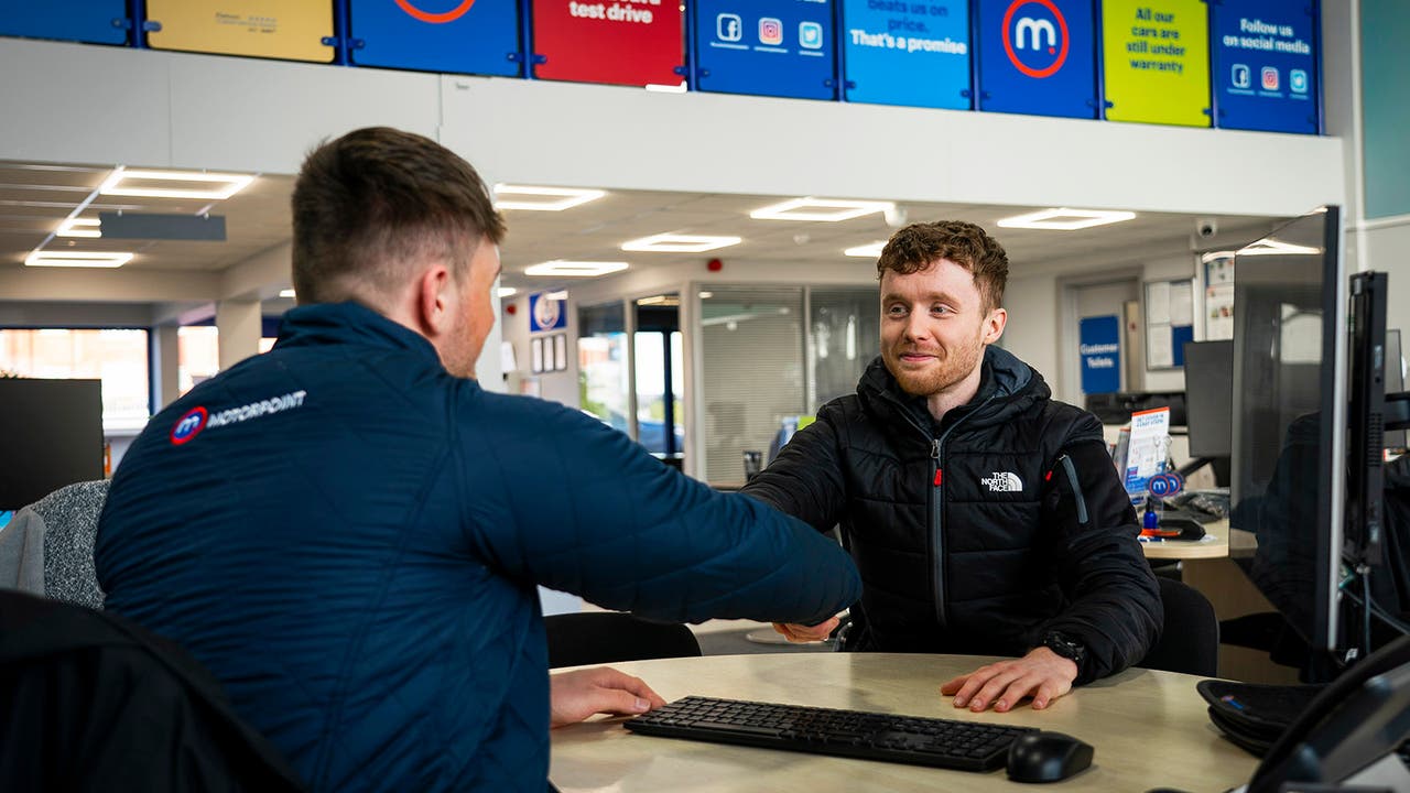 Motorpoint sales executive and customer shaking hands