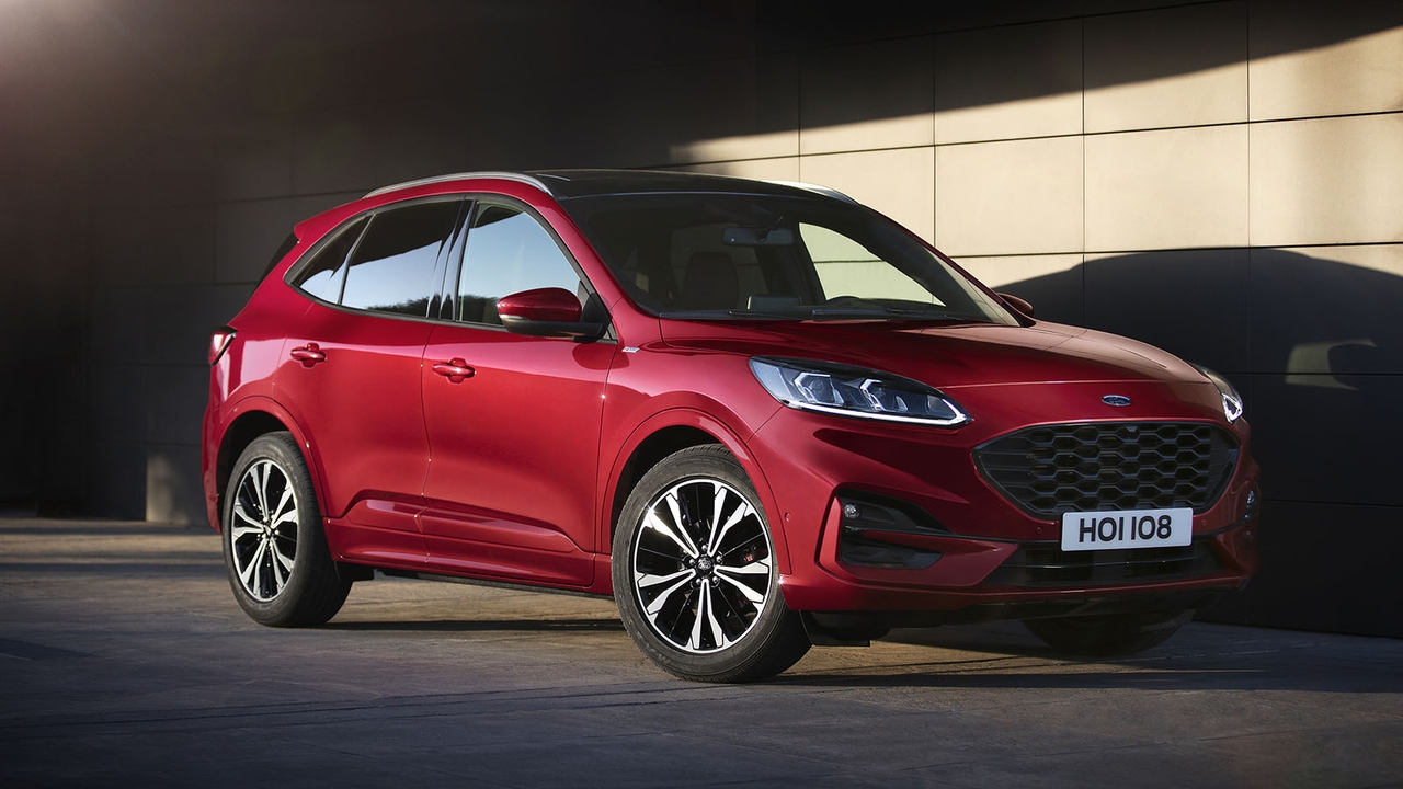 Red Ford Kuga parked against a wall