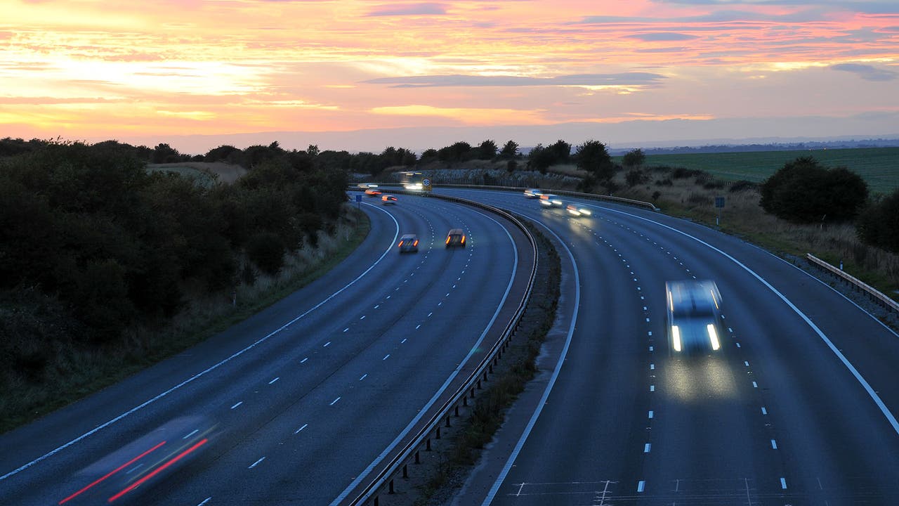 Shot of UK motorway at dusk with fast-moving traffic