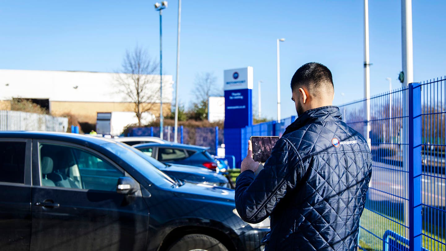 Motorpoint sales executive photographs a part-exchange vehicle