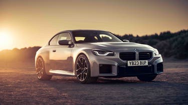 BMW M2 front three-quarter view in front of sunset