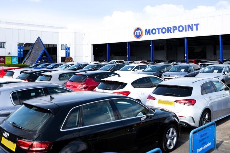Rows of used cars for sale outside a Motorpoint store