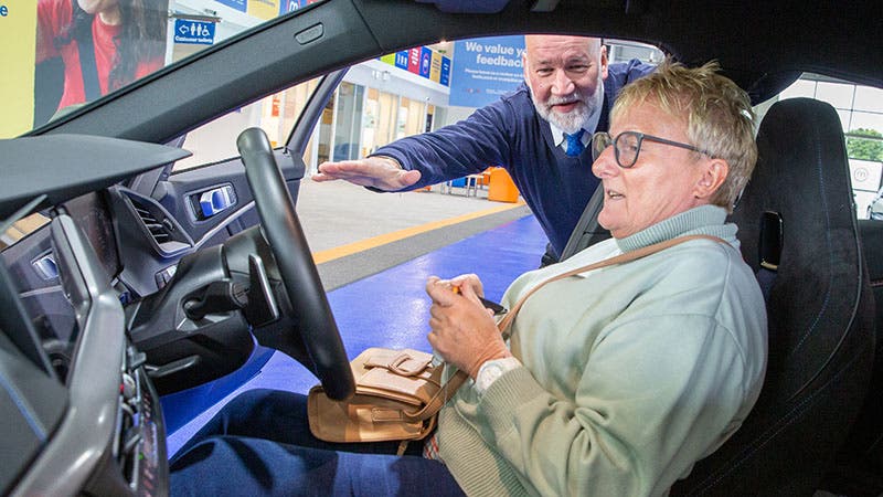 A Motorpoint customer being shown her new car by a member of staff