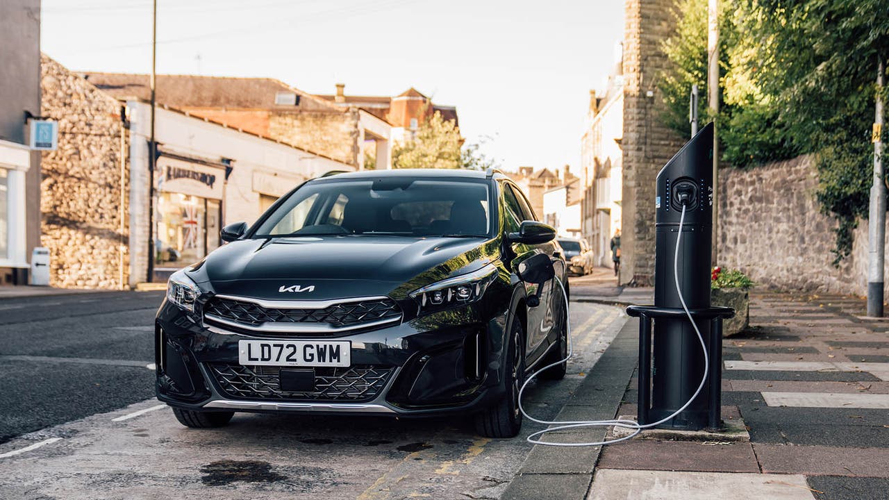 A Kia Xceed PHEV in black, charging