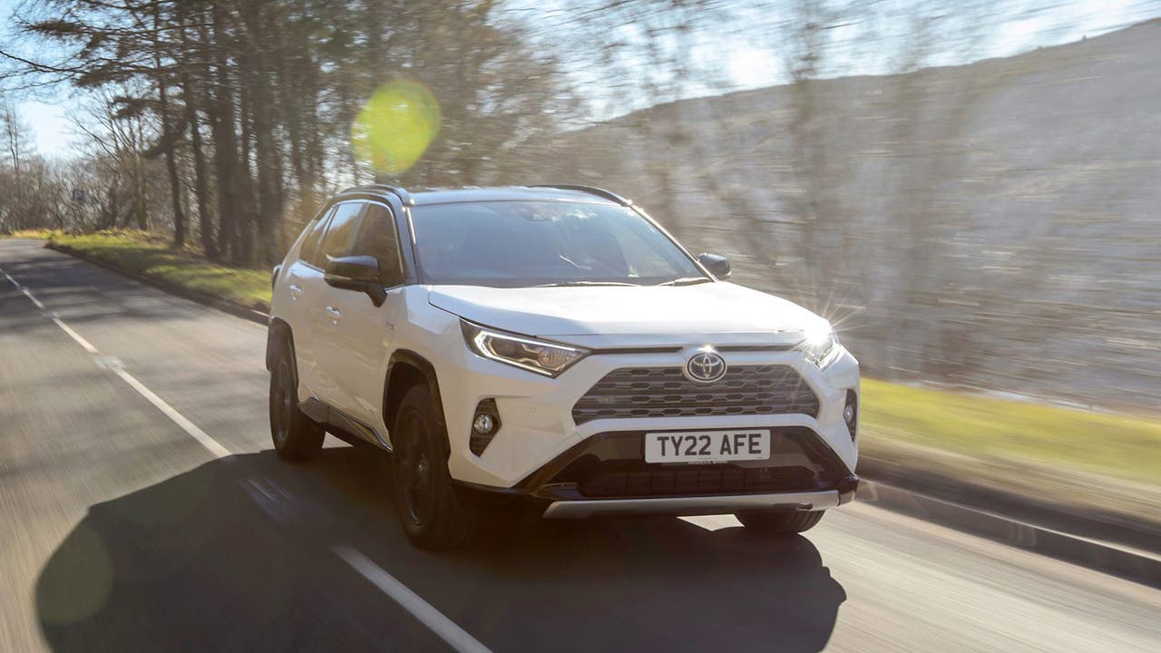 Toyota RAV4 in white, driving shot