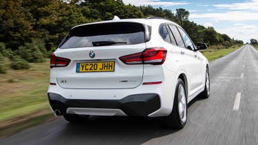 BMW X1 driving rear view