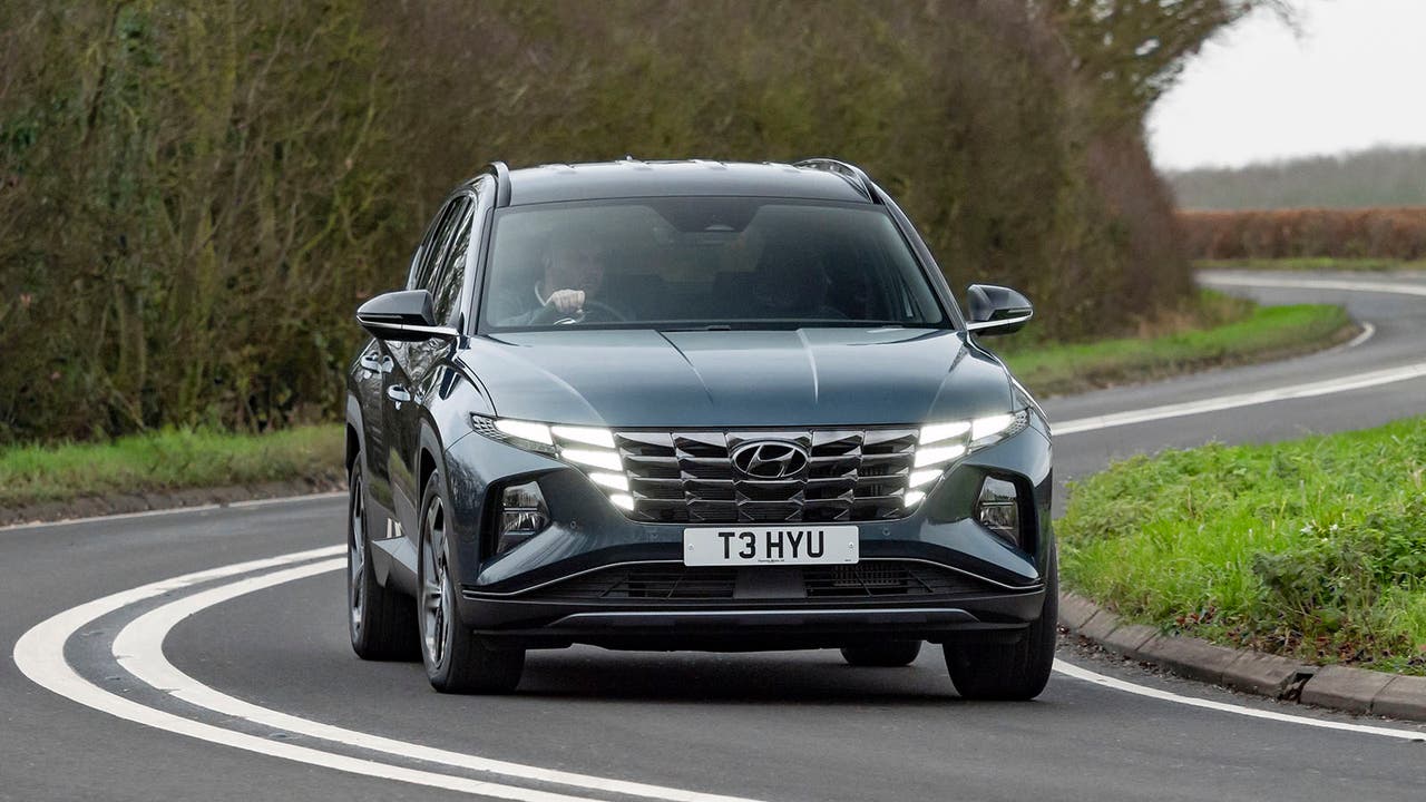 Hyundai Tucson in blue, driving shot