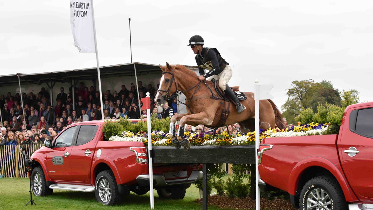 Horse jumping over Mitsubishi L200 pickups at Badminton Horse Trials 2018