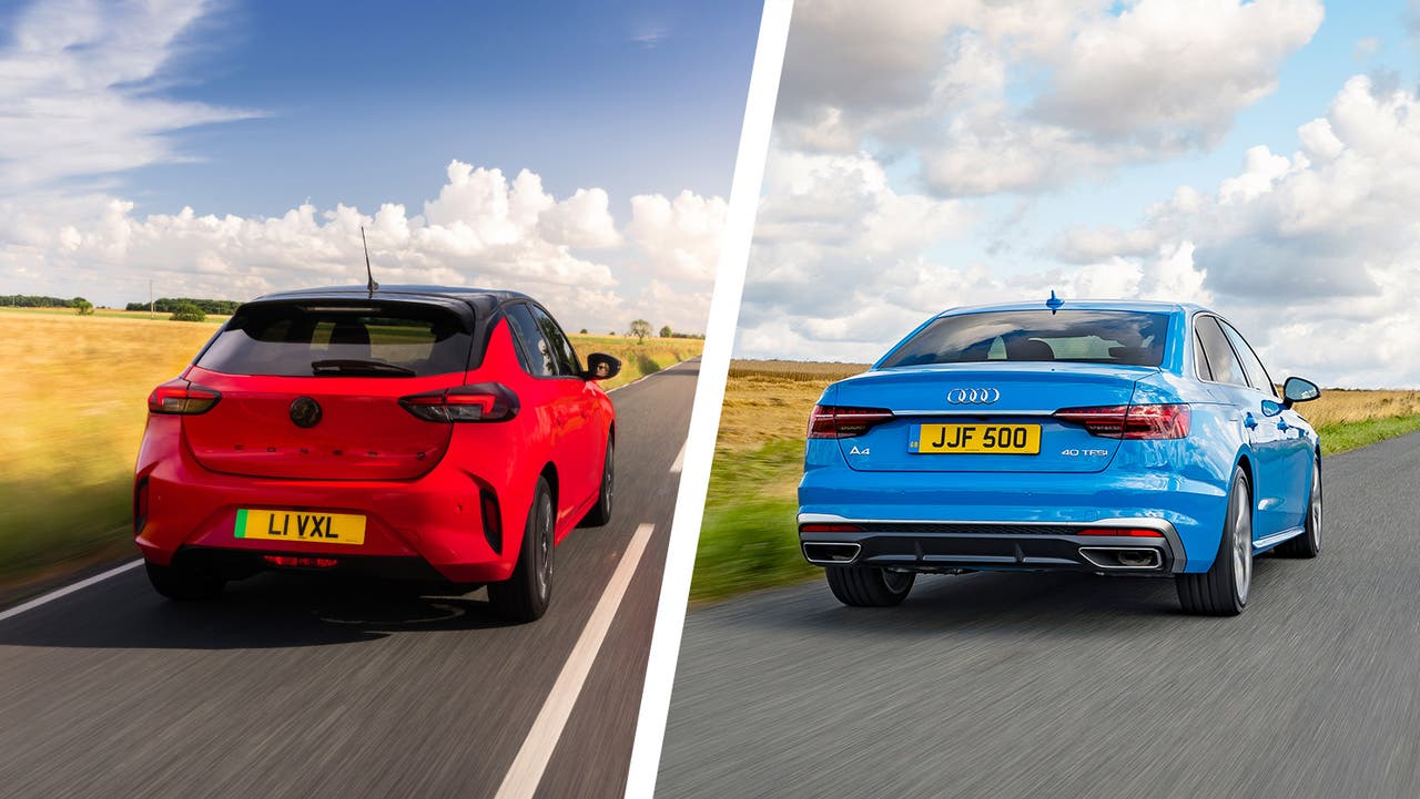Vauxhall Corsa hatchback in red vs Audi A4 saloon in blue. Rear three quarter driving shot.