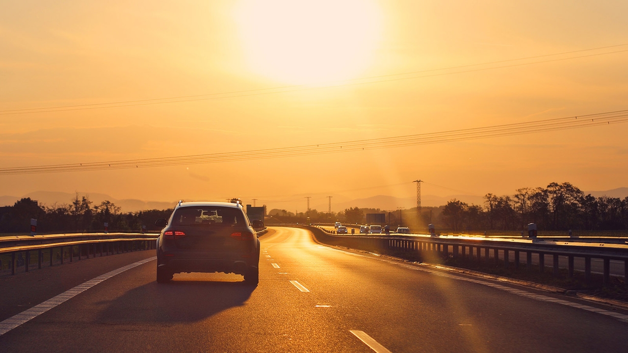 Car driving on road in the sun