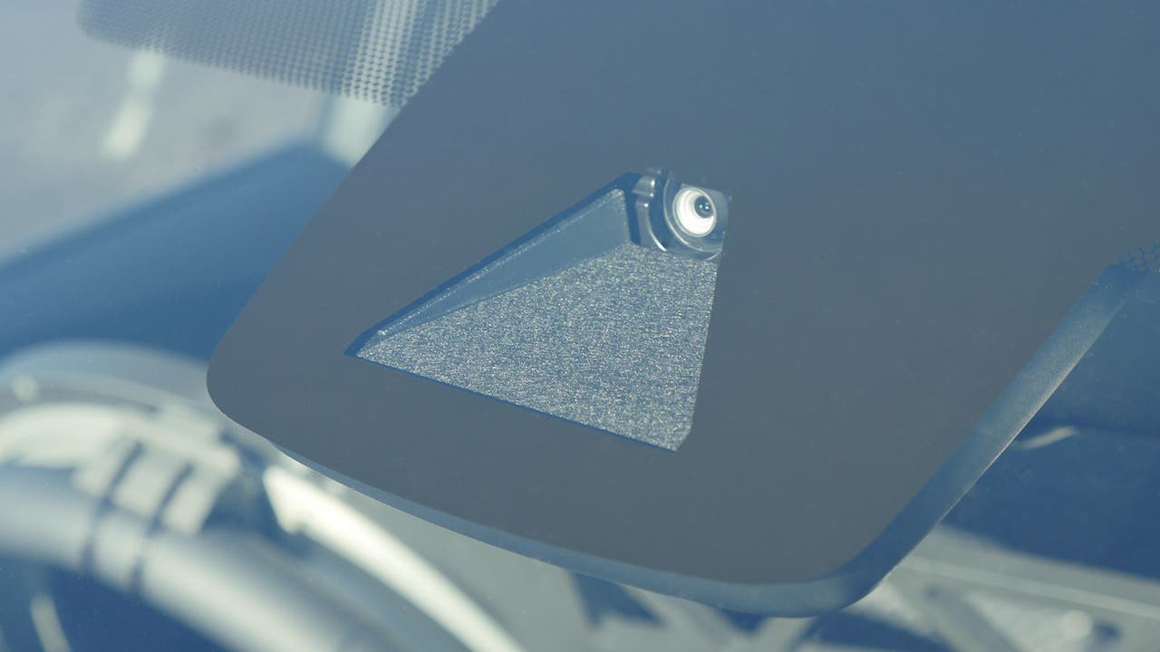 A car ADAS sensor behind the rear-view mirror
