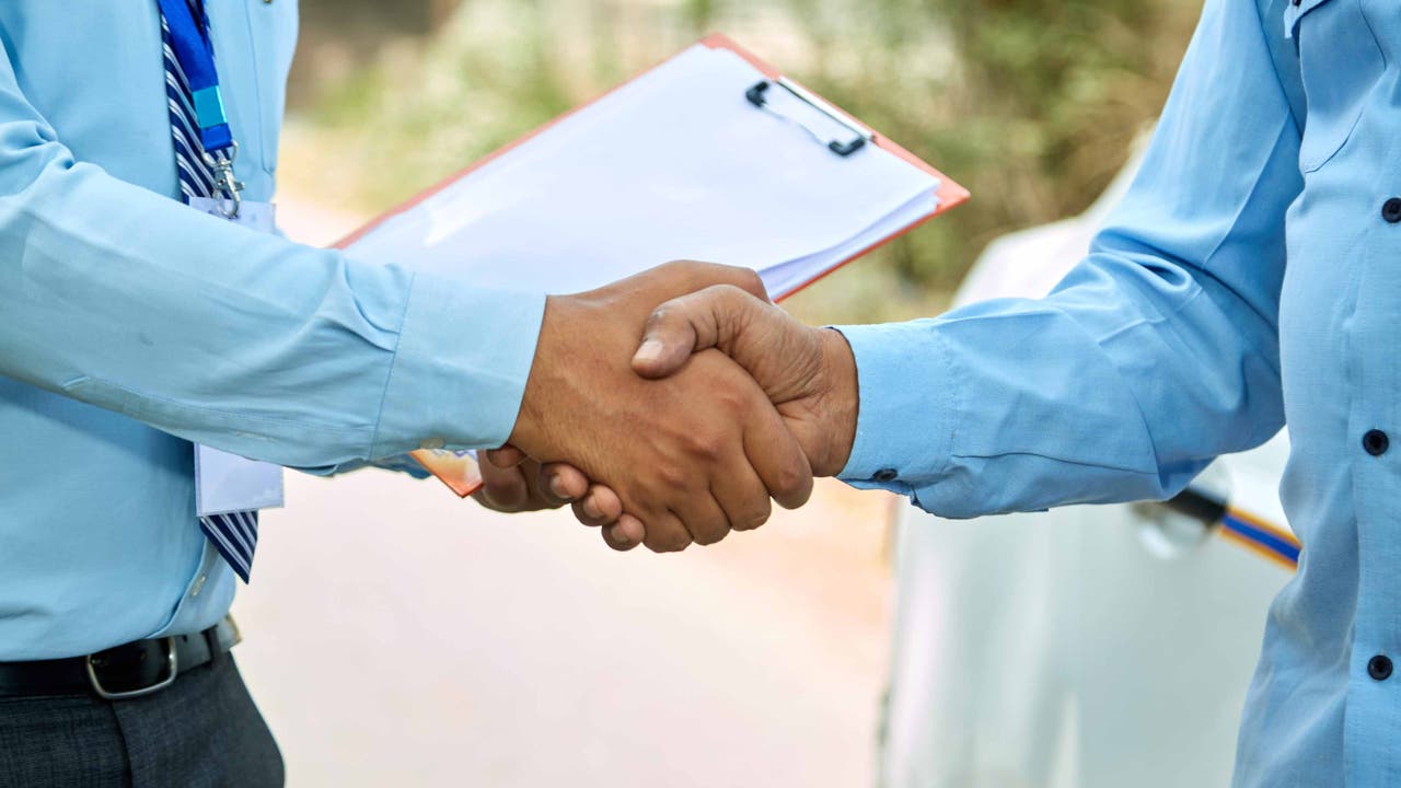 Salesman shaking hands with customer