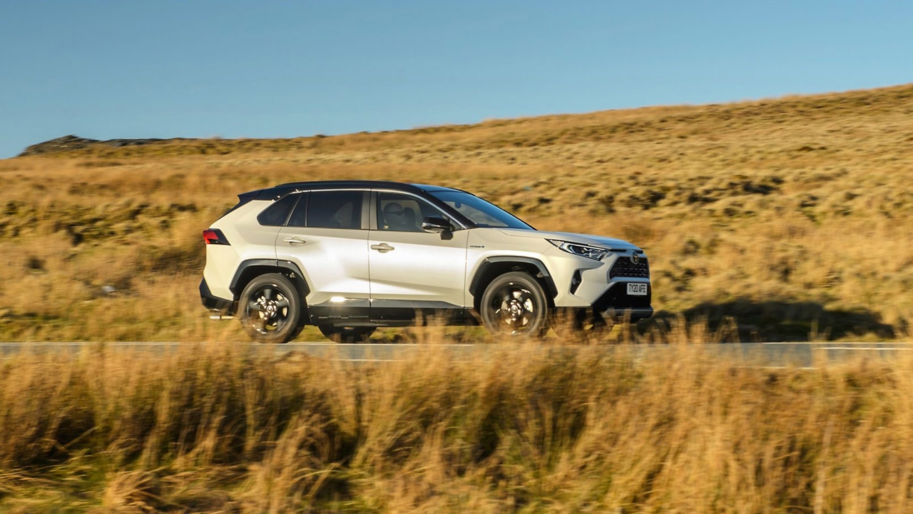 Toyota RAV4 in white, side driving shot