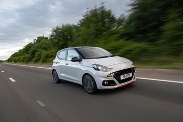 White Hyundai i10 N Line driving along a road