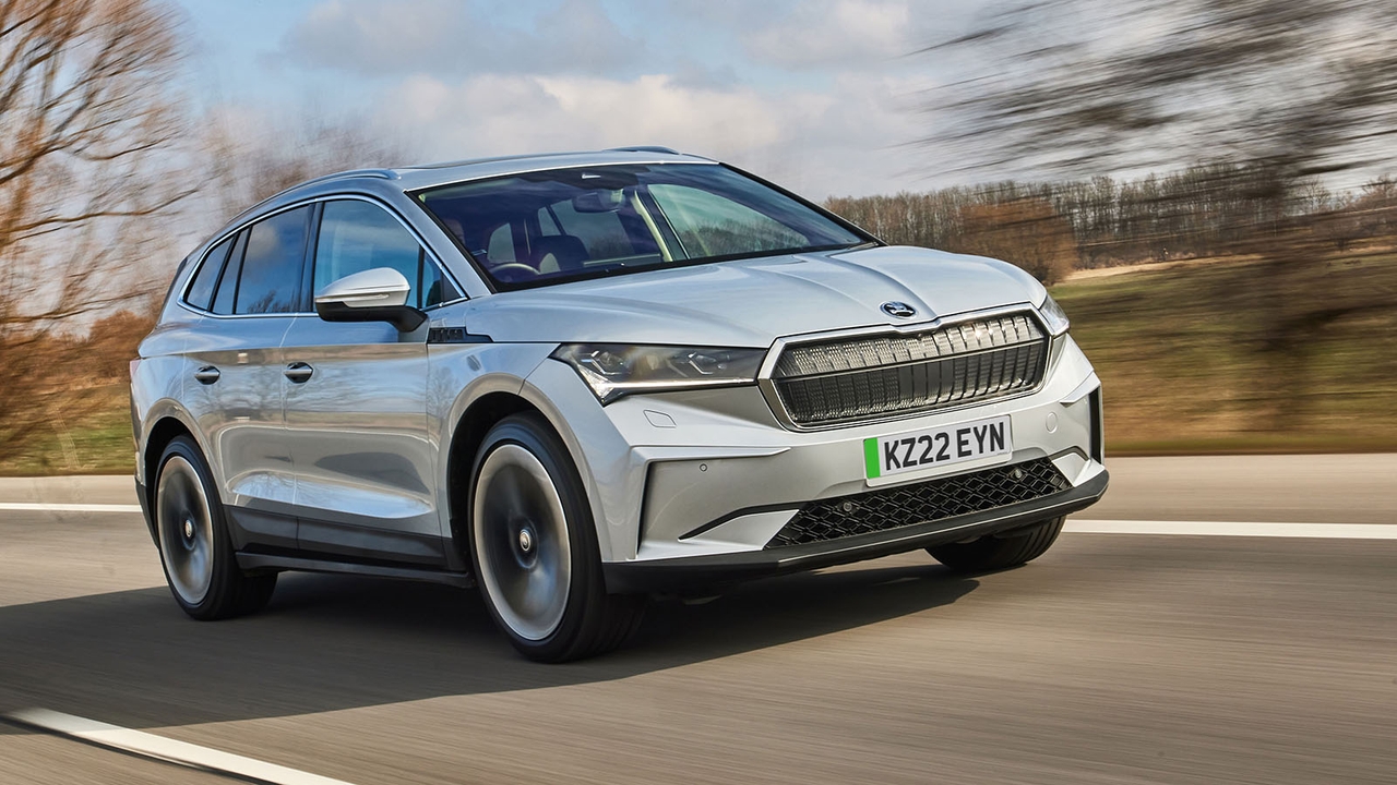 Silver Skoda Enyaq iV driving past a forestry block