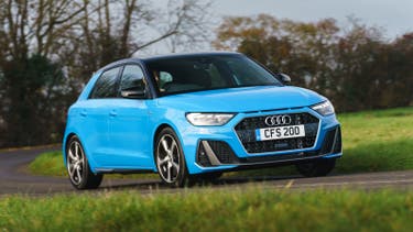 Blue Audi A1 driving around corner