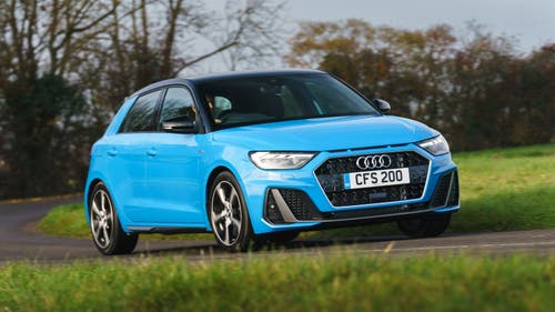 Blue Audi A1 driving around corner