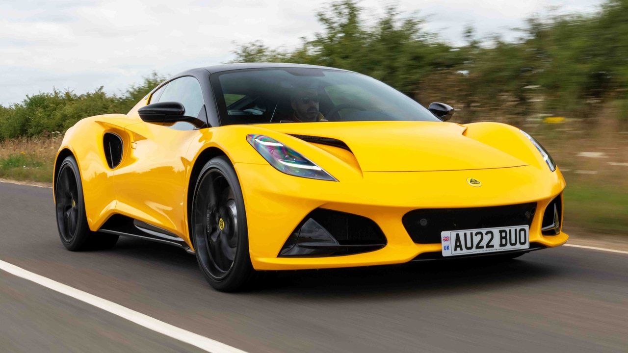 Lotus Emira V6 in yellow driving down road