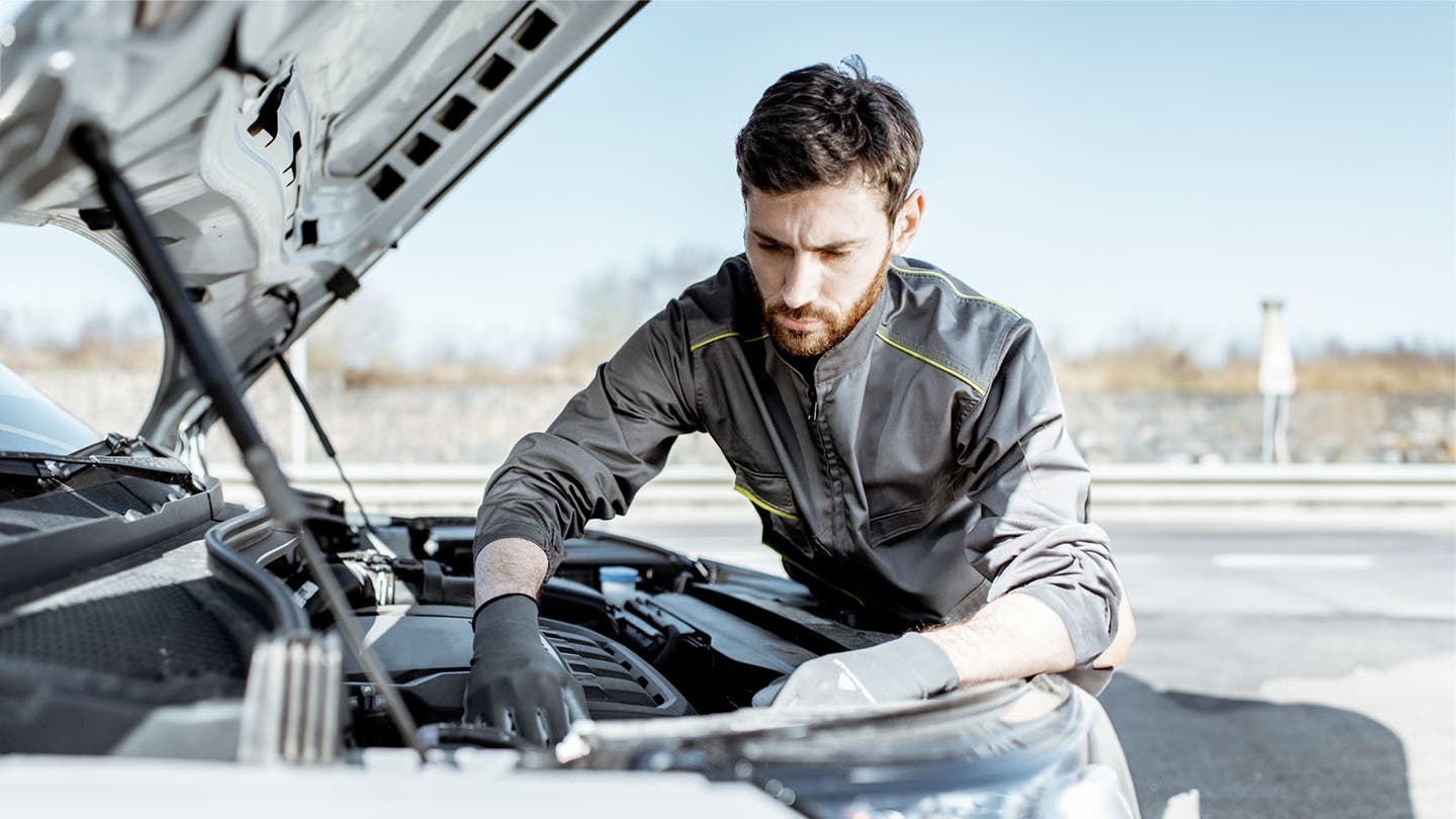 mechanic checking car engine