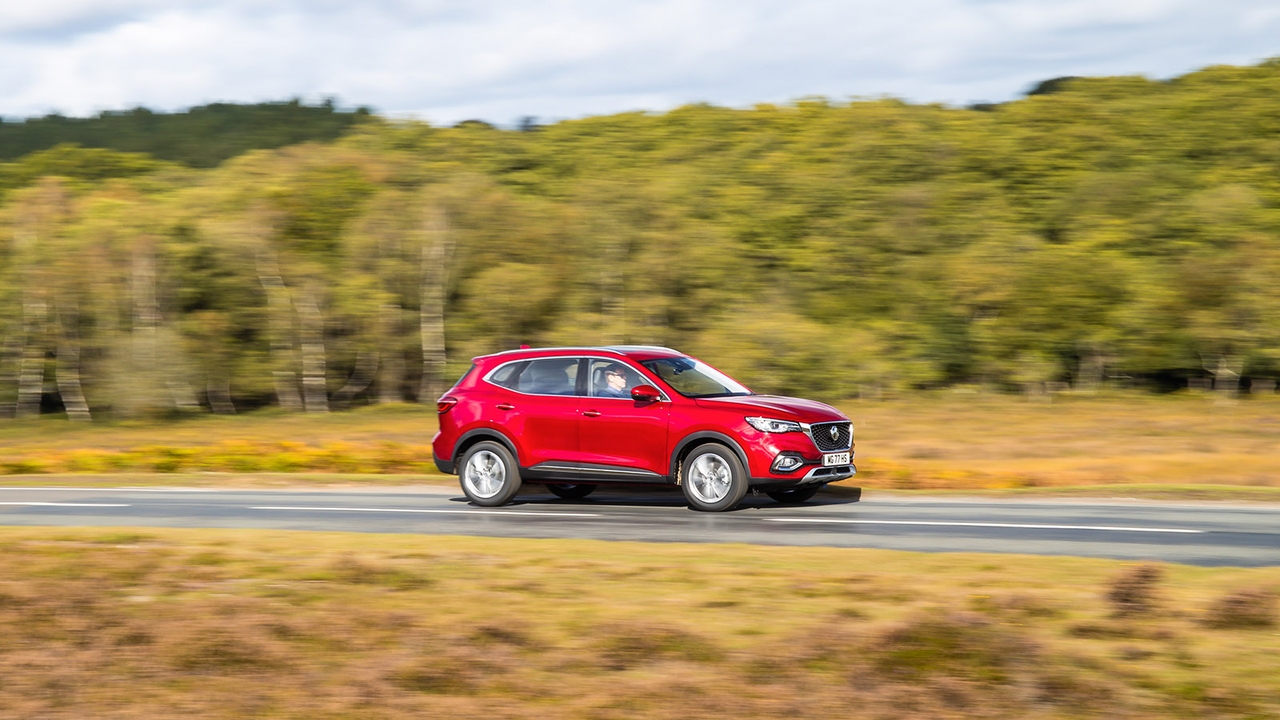 MG HS in red side on driving shot through countryside