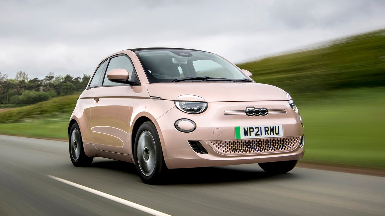 Fiat 500 Electric in rose gold driving front three quarter shot