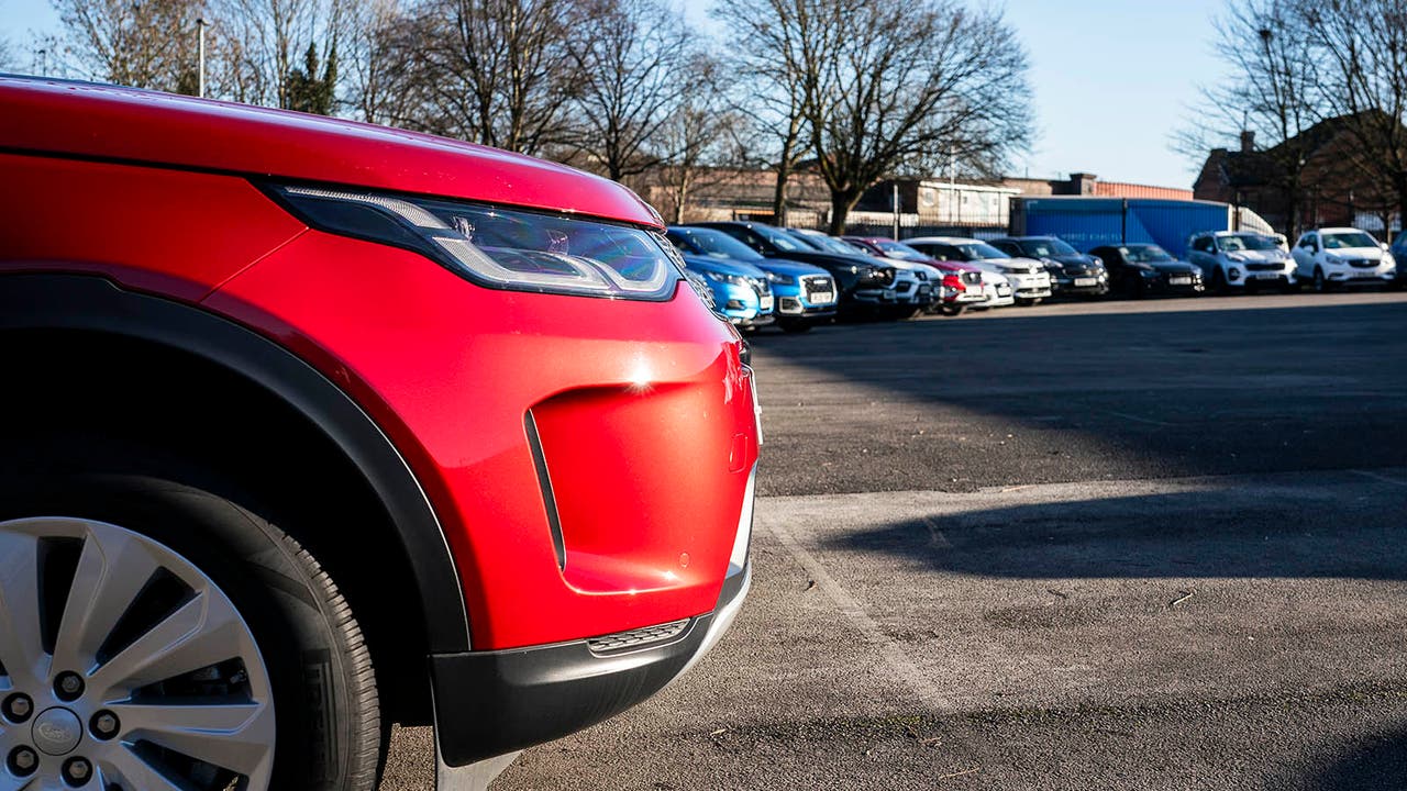 Closeup of red Land Rover Discovery Sport at Motorpoint store