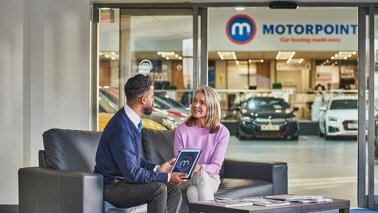 Customer talks with Motorpoint salesperson at a Motorpoint store