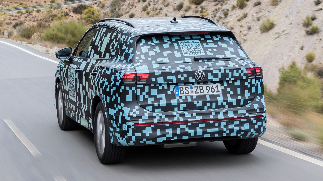 2024 VW Tiguan in camouflage, driving, rear view