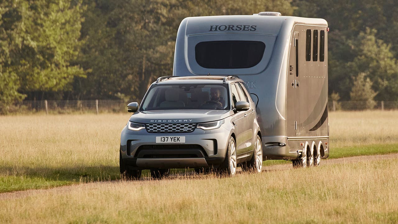 Land Rover Discovery in grey, towing horse box