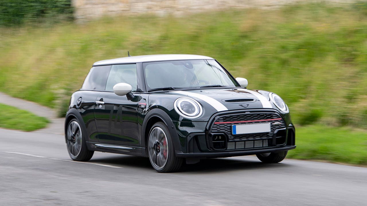 Mini Hatchback Cooper S three-door in black, driving shot